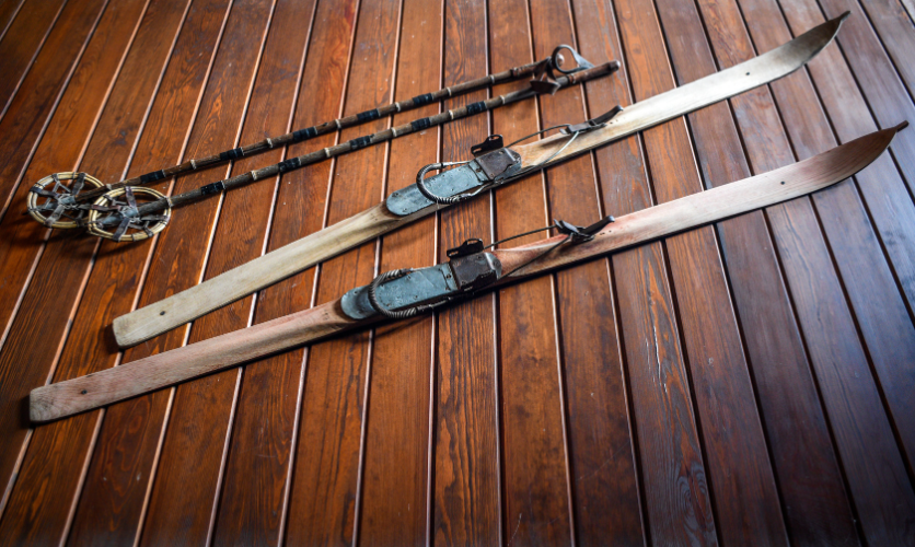 The history of Skis and Ski Poles, an image of old fashioned wooden skis and poles 
