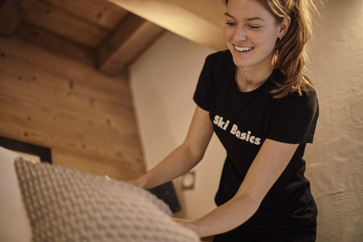 Work experience on a ski season - Woman making a bed in a Ski Basics Catered Chalet in Meribel