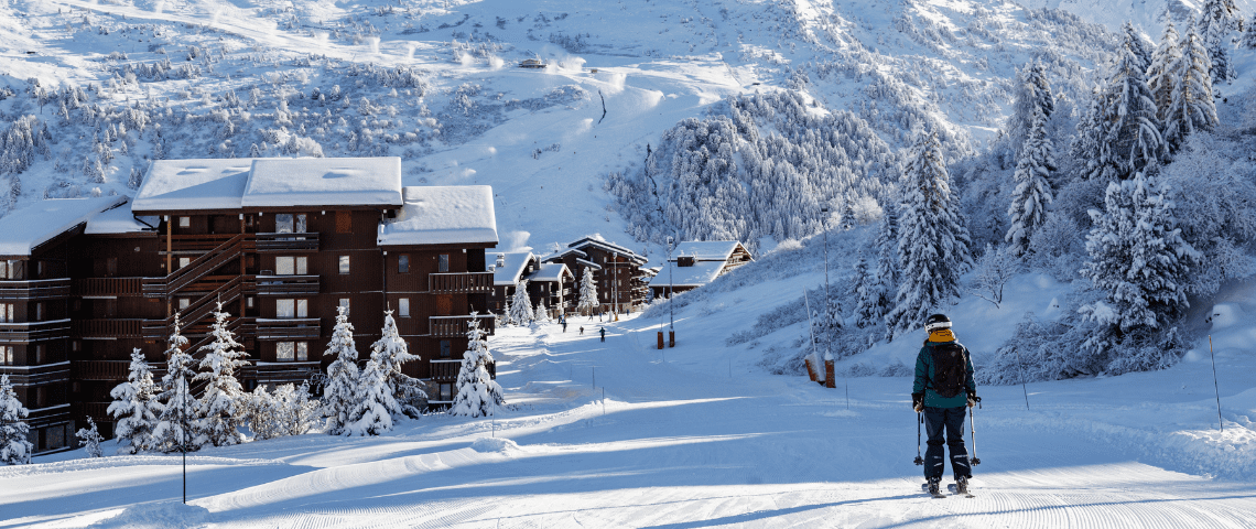 how much does a ski trip cost? A complete guide to ski holiday cost in Meribel. Skier skiing down into Meribel