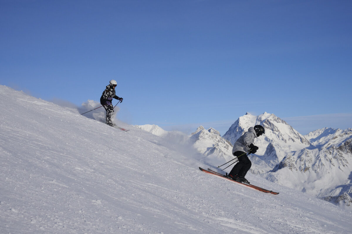 Should I do a Ski Season? Two people skiing down a mountain on a ski season in Meribel 