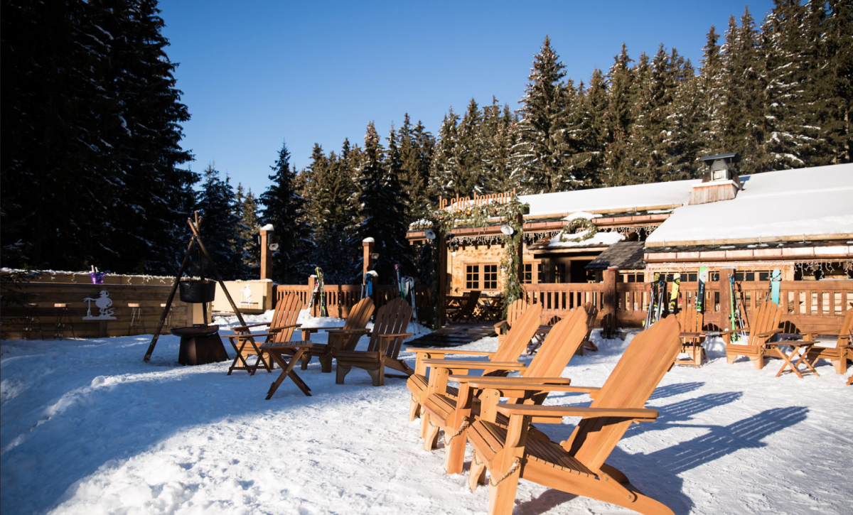 Wooden chairs in the sun on the snow