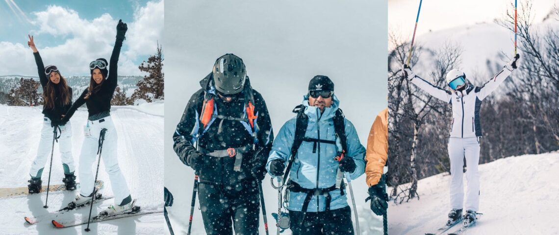 Three skiers wearing helmets, goggles, insulated ski jackets, salopettes and gloves on a snowy slope, showing what to wear skiing in 2026.
