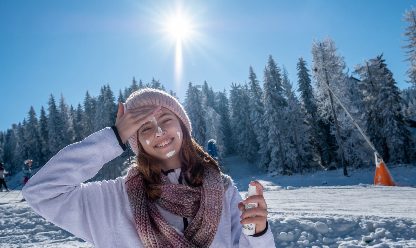 Sunscreen and SPF protection at high altitude - girl applying spf on the ski slope
